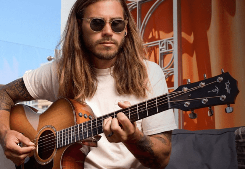 Person playing the new builders edition 814ce guitar by Taylor