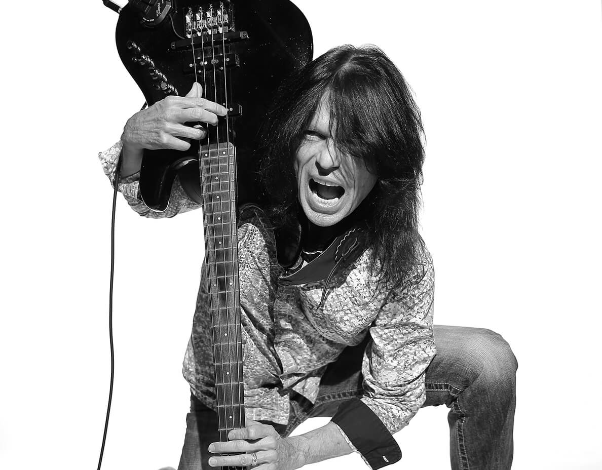 Rudy Sarzo holding guitar