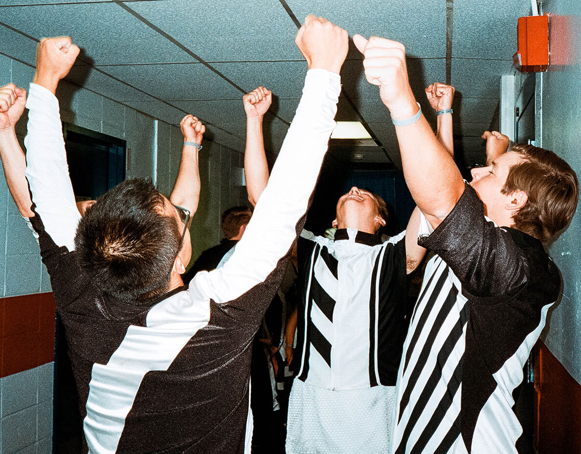 four people raising fists while looking up