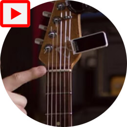 person pointing to guitar