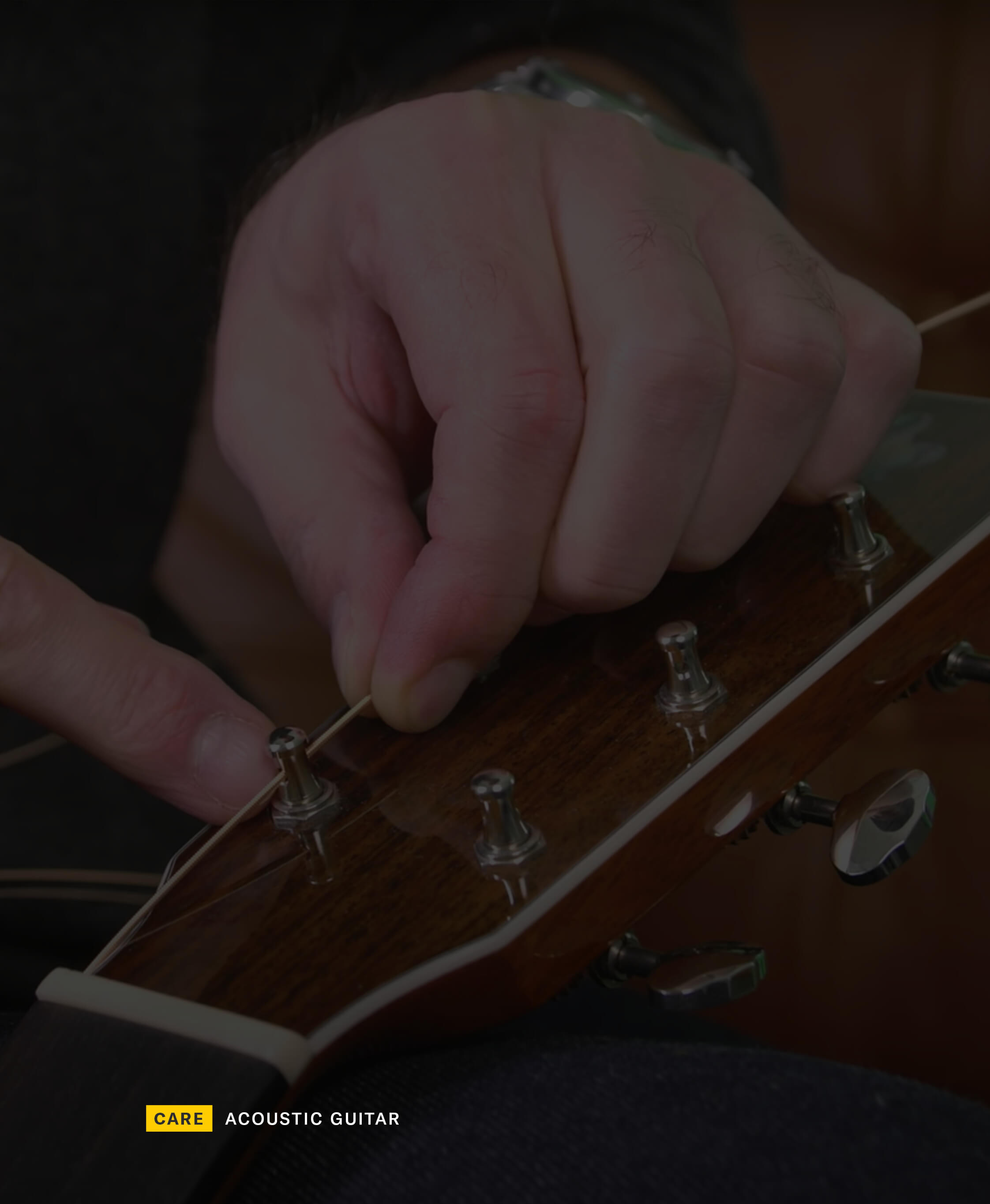 Person restringing a guitar