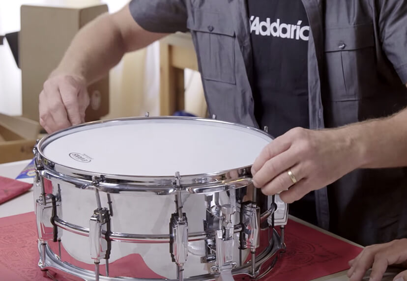 Person changing snare drumhead