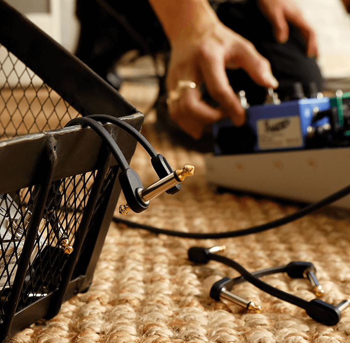 Flat Patch cables next to pedalboard 